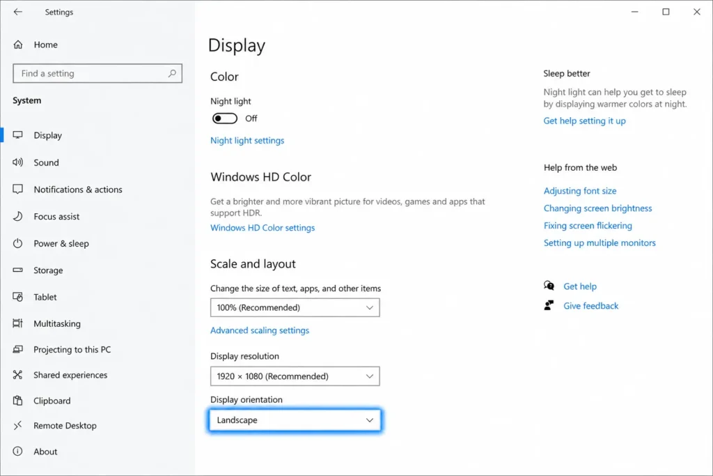 Windows 10 Settings screen showing Display Orientation dropdown in Scale and Layout section