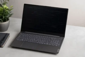Lenovo laptop with black screen display issue on desk, showing common Lenovo laptop display problems